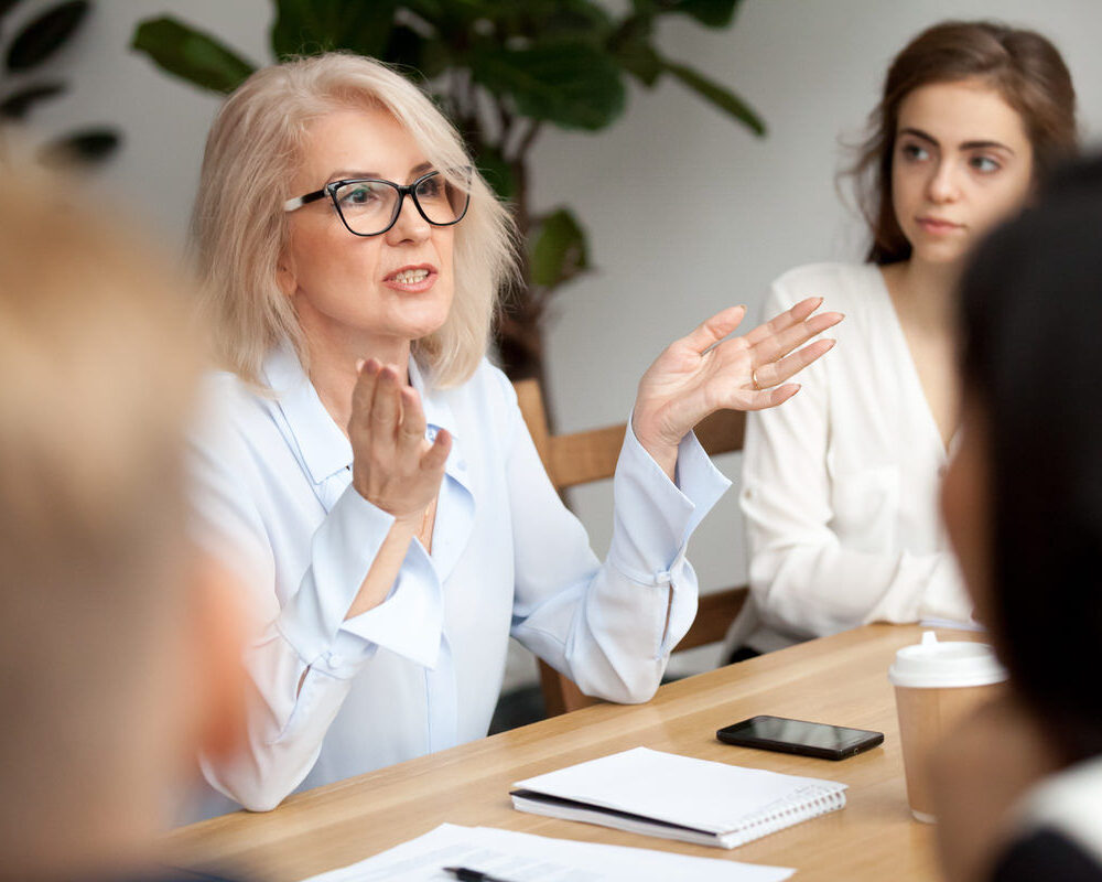Attractive,Aged,Businesswoman,,Teacher,Or,Mentor,Coach,Speaking,To,Young Attractive,Aged,Businesswoman,,Teacher,Or,Mentor,Coach,Speaking,To,Young