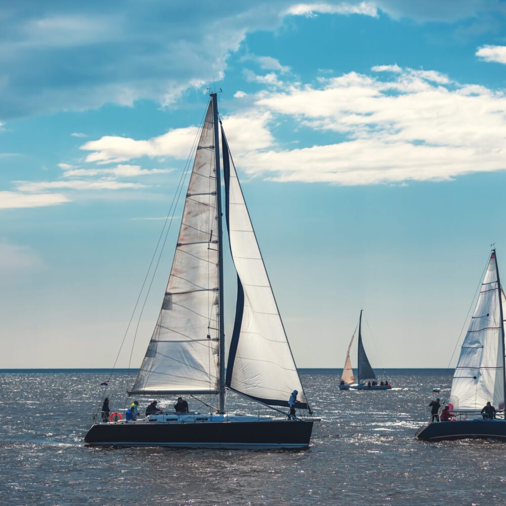 Sailing ship yacht with white sails in the sea.